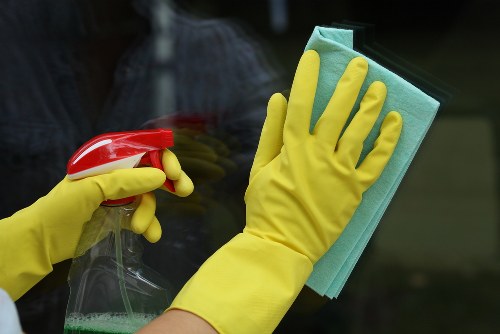 Professional home cleaner tidying a bright living room in Harringay