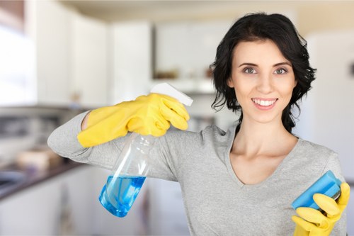 Technician using upholstery cleaning equipment on a couch
